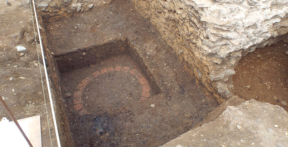 Exposed post-medieval well and Roman wall