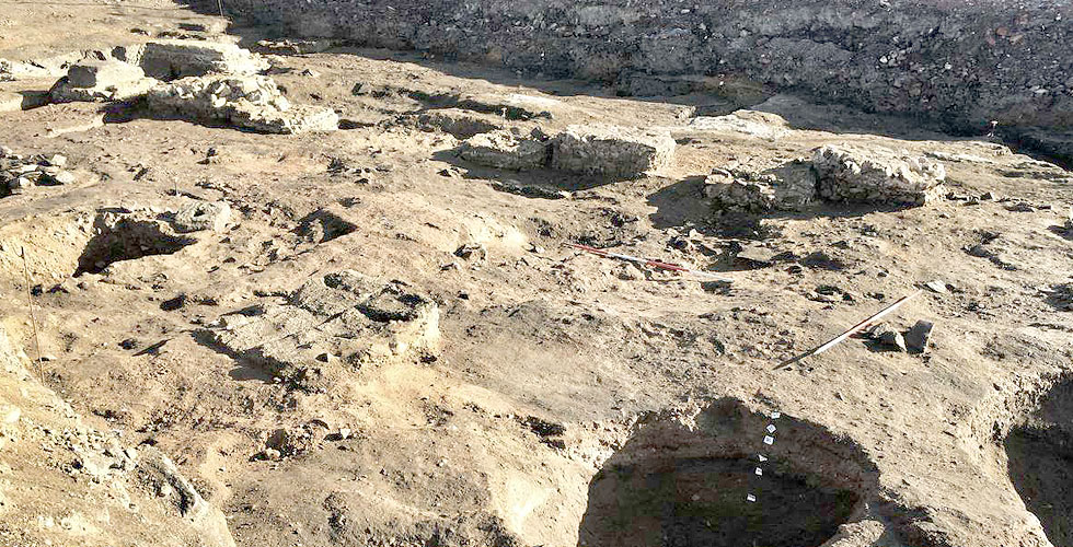 Inside the Roman building with floor layers exposed