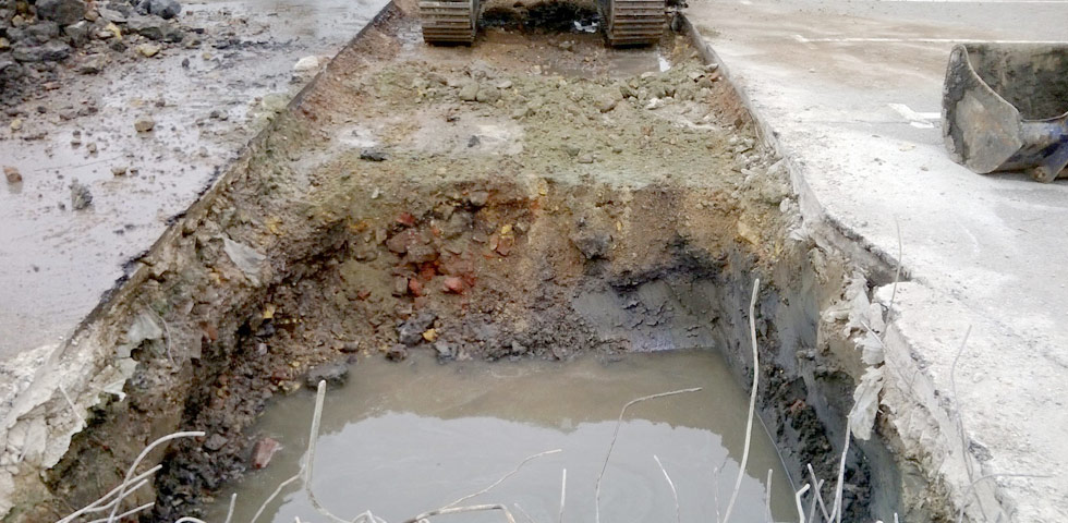 Trench with contaminated water and reinforced concrete slab